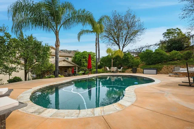 an aerial view of a house with a garden and a car park