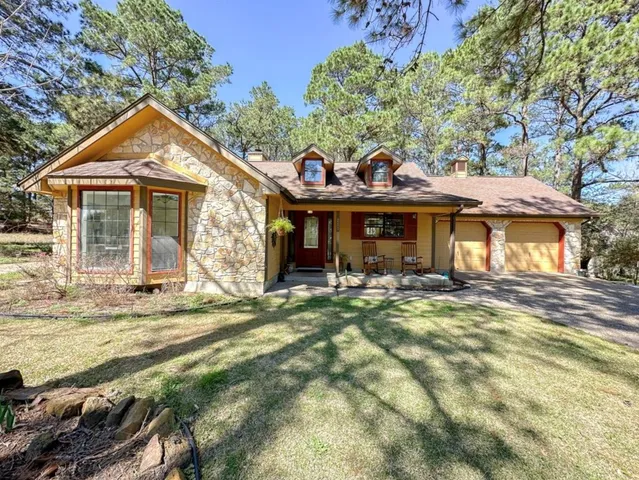 a view of a house with garden and porch