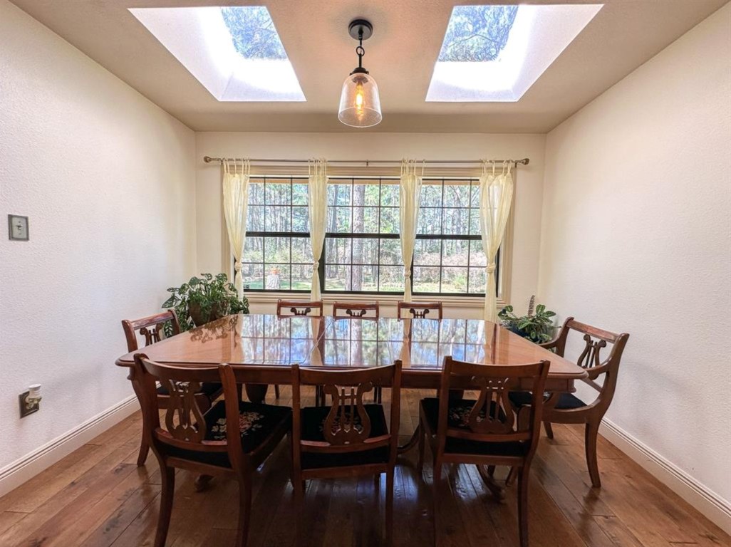 251 Pine View Loop Bastrop, TX 78602 - Photo 12 of 30 a view of a dining room with furniture and wooden floor