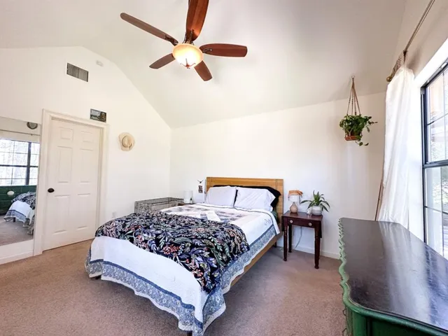 a bedroom with a large bed and a large window