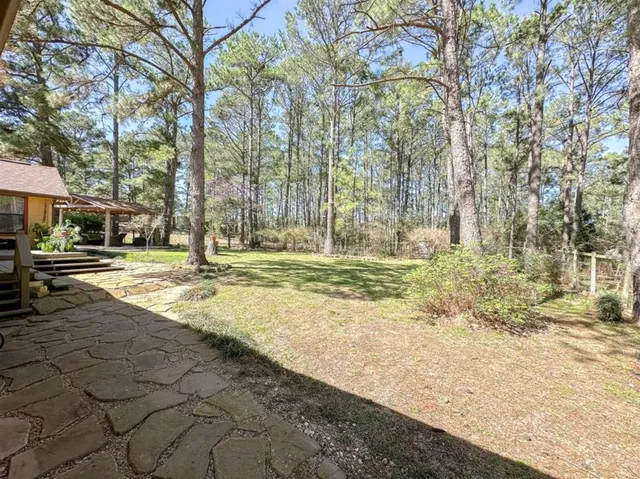 a view of a small house with wooden fence