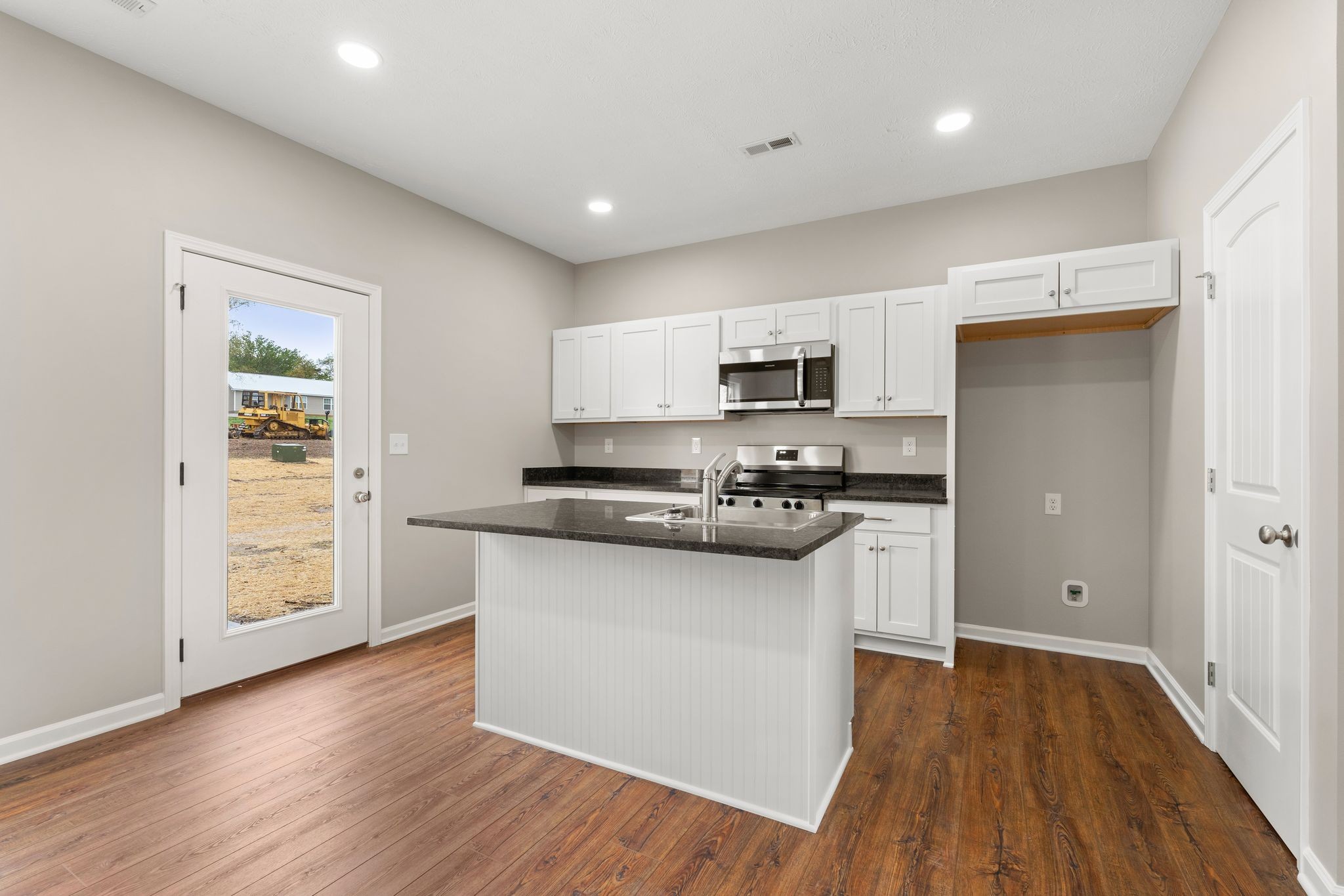 803 Shepard Street South Winchester, TN 37398 - Photo 12 of 33 a kitchen with stainless steel appliances a sink cabinets and wooden floor