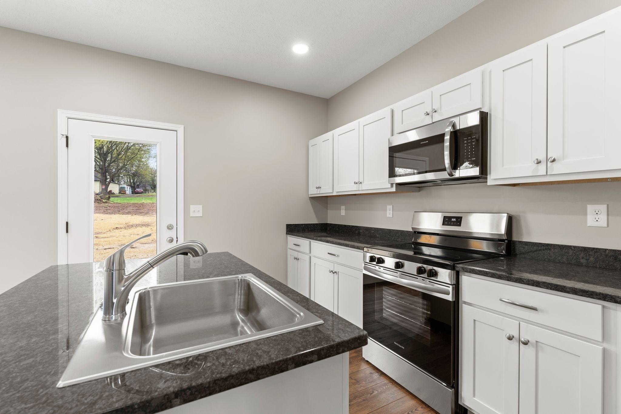 803 Shepard Street South Winchester, TN 37398 - Photo 15 of 33 a kitchen with stainless steel appliances granite countertop a sink stove and microwave