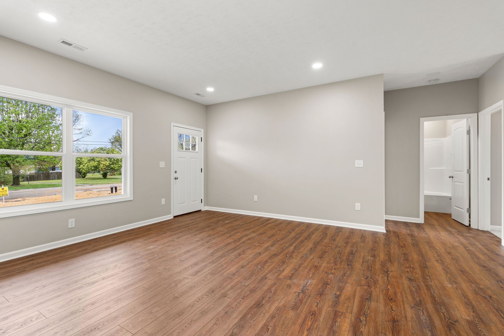 803 Shepard Street South Winchester, TN 37398 - Photo 9 of 33 an empty room with wooden floor and windows
