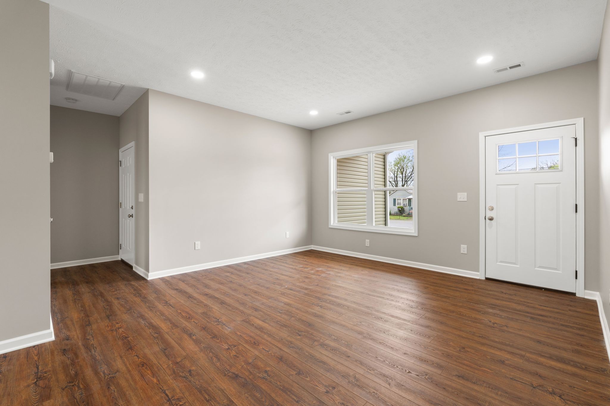 803 Shepard Street South Winchester, TN 37398 - Photo 10 of 33 an empty room with wooden floor and windows