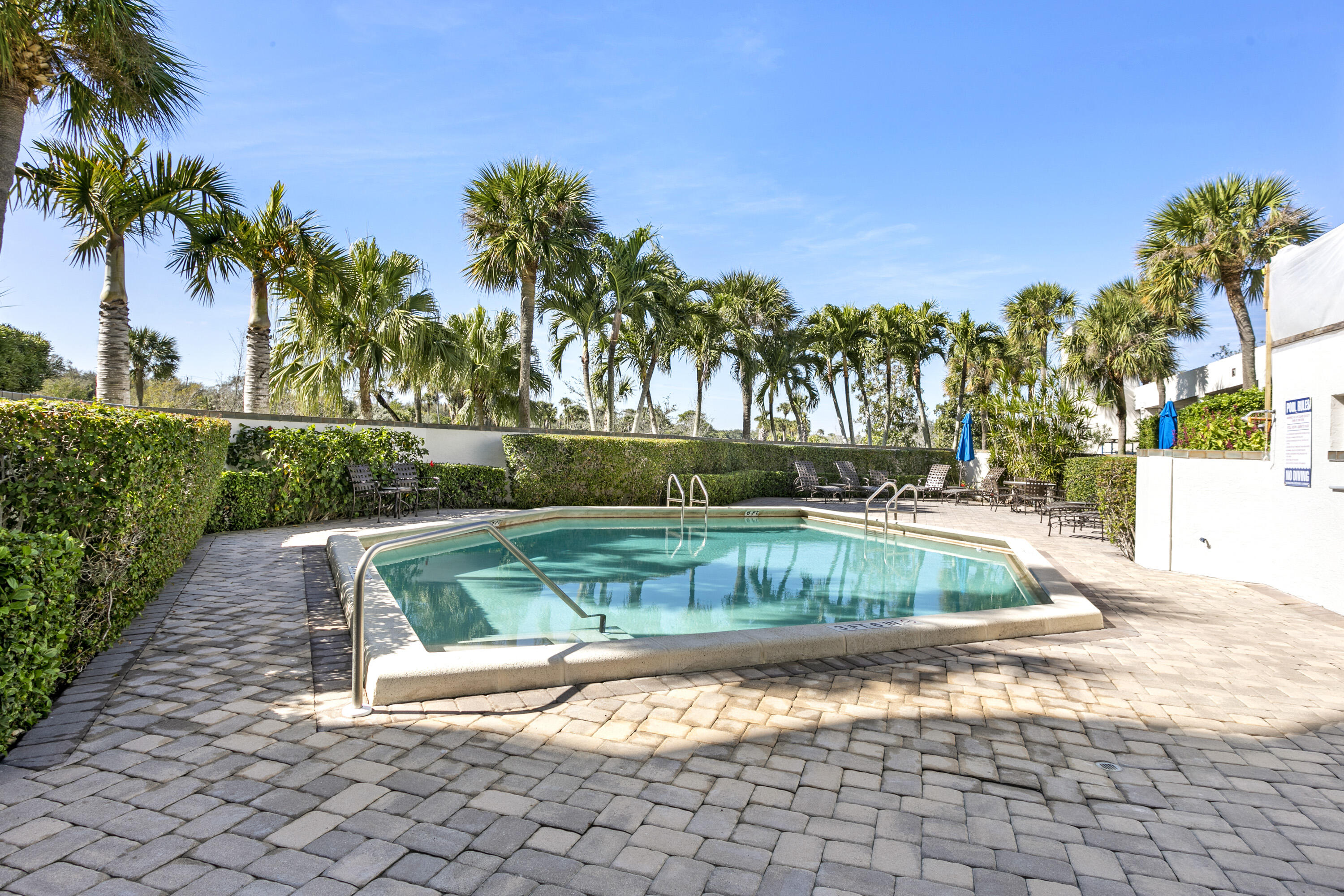 3322 Casseekey Island Road, Unit 504 Jupiter, FL 33477 - Photo 37 of 46 a view of backyard with swimming pool and outdoor seating