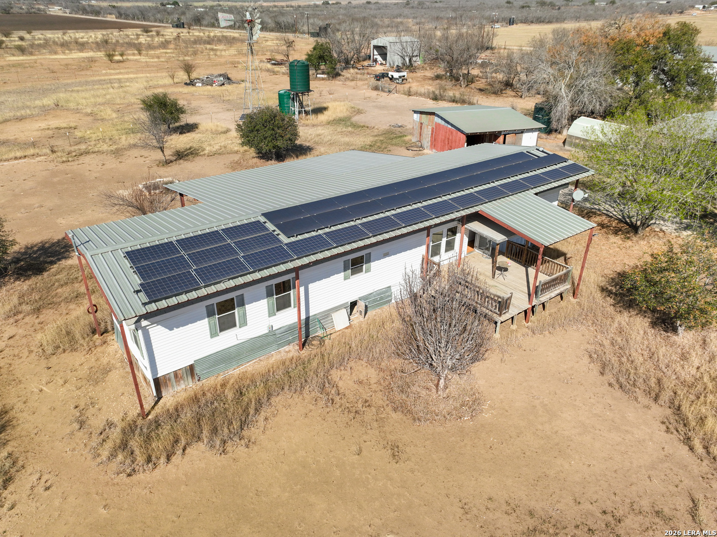 4919 County Road 545 Devine, TX 78016 - Photo 1 of 38 a view of a roof deck with wooden floor