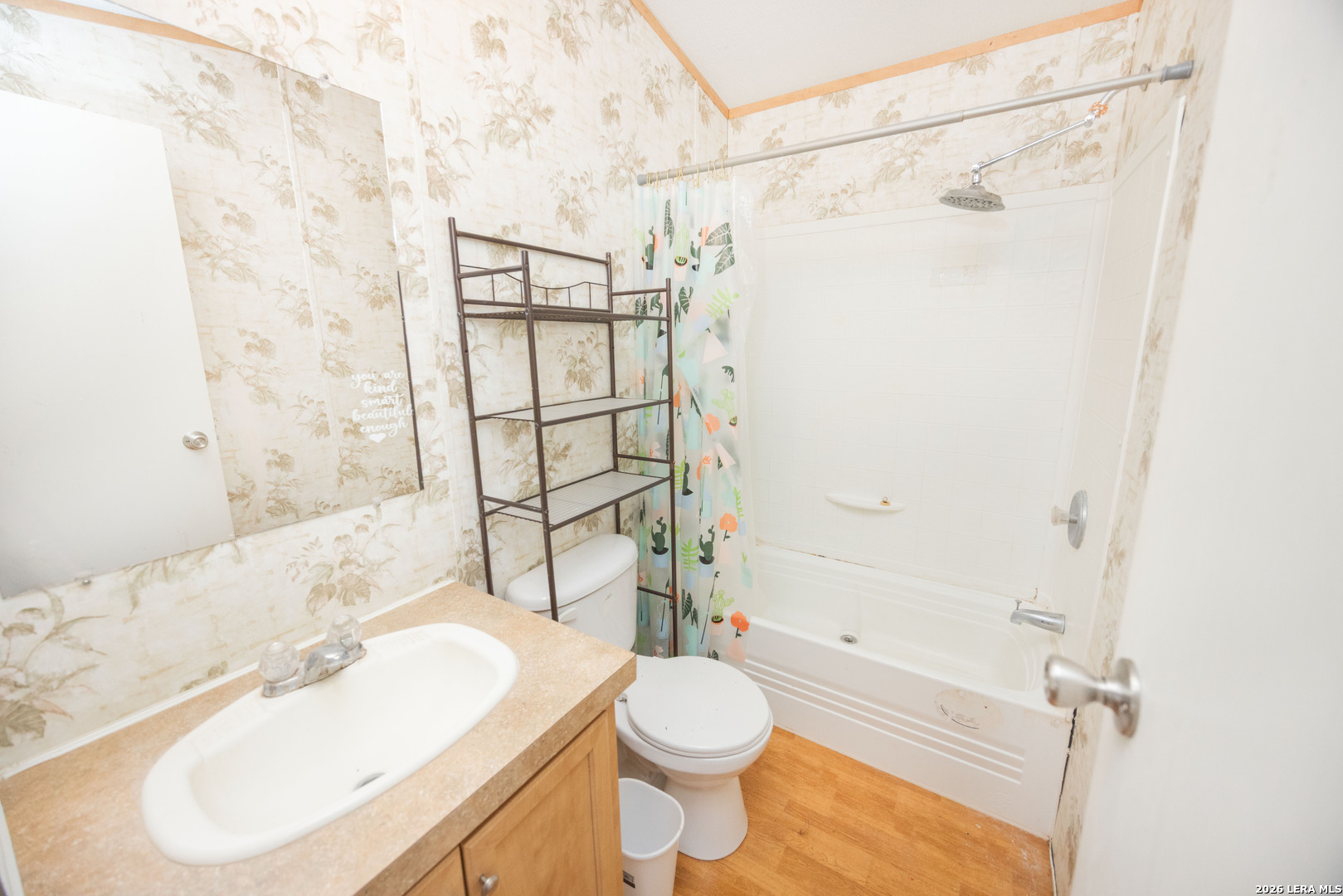 4919 County Road 545 Devine, TX 78016 - Photo 12 of 38 a bathroom with a sink toilet and shower