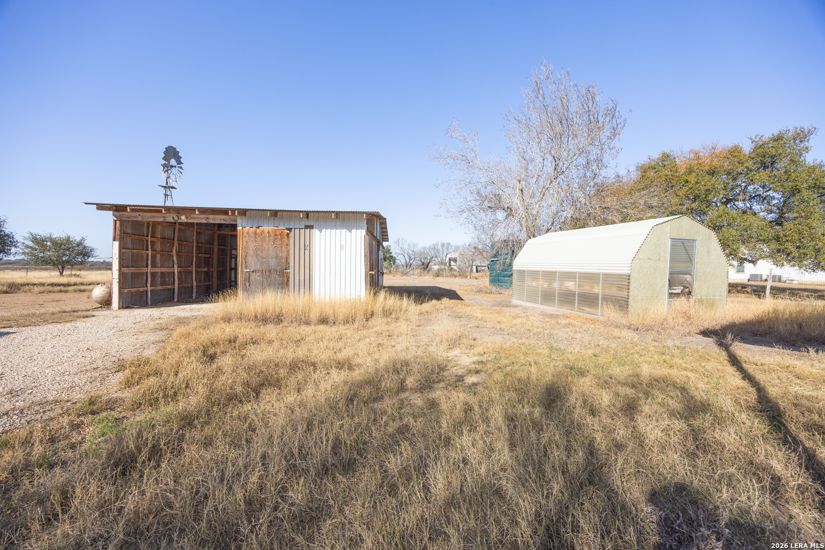 4919 County Road 545 Devine, TX 78016 - Photo 17 of 38 a view of a house with backyard and trees