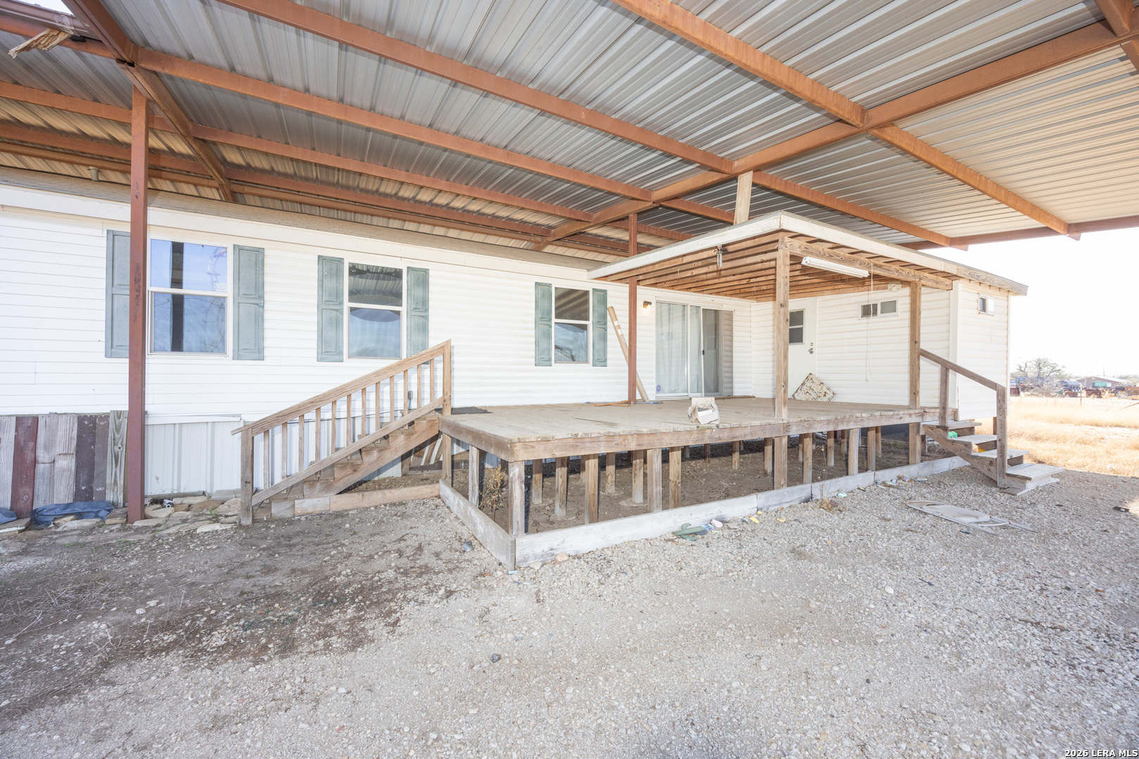 4919 County Road 545 Devine, TX 78016 - Photo 2 of 38 a view of a house with wooden deck