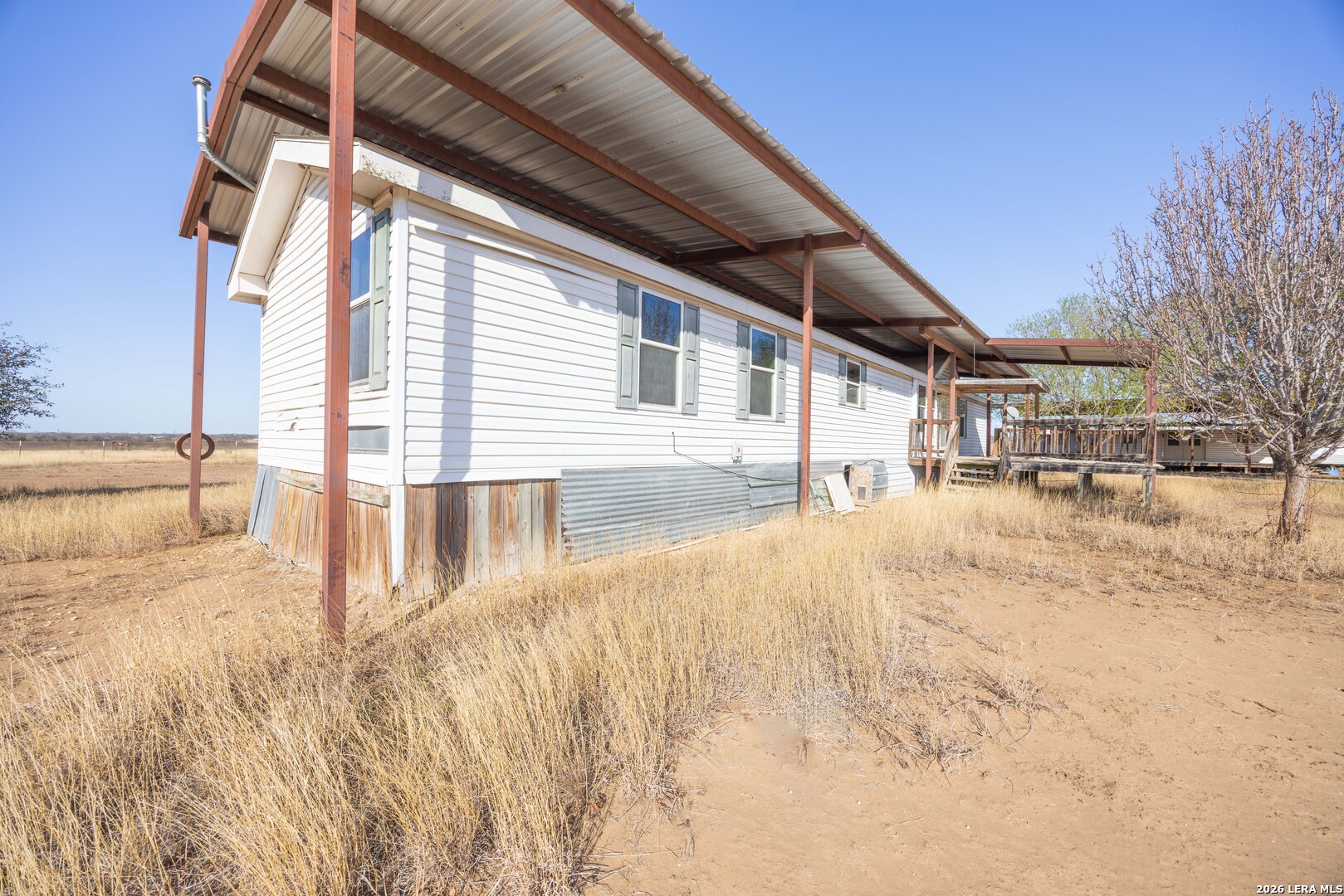 4919 County Road 545 Devine, TX 78016 - Photo 21 of 38 a view of a house with a yard