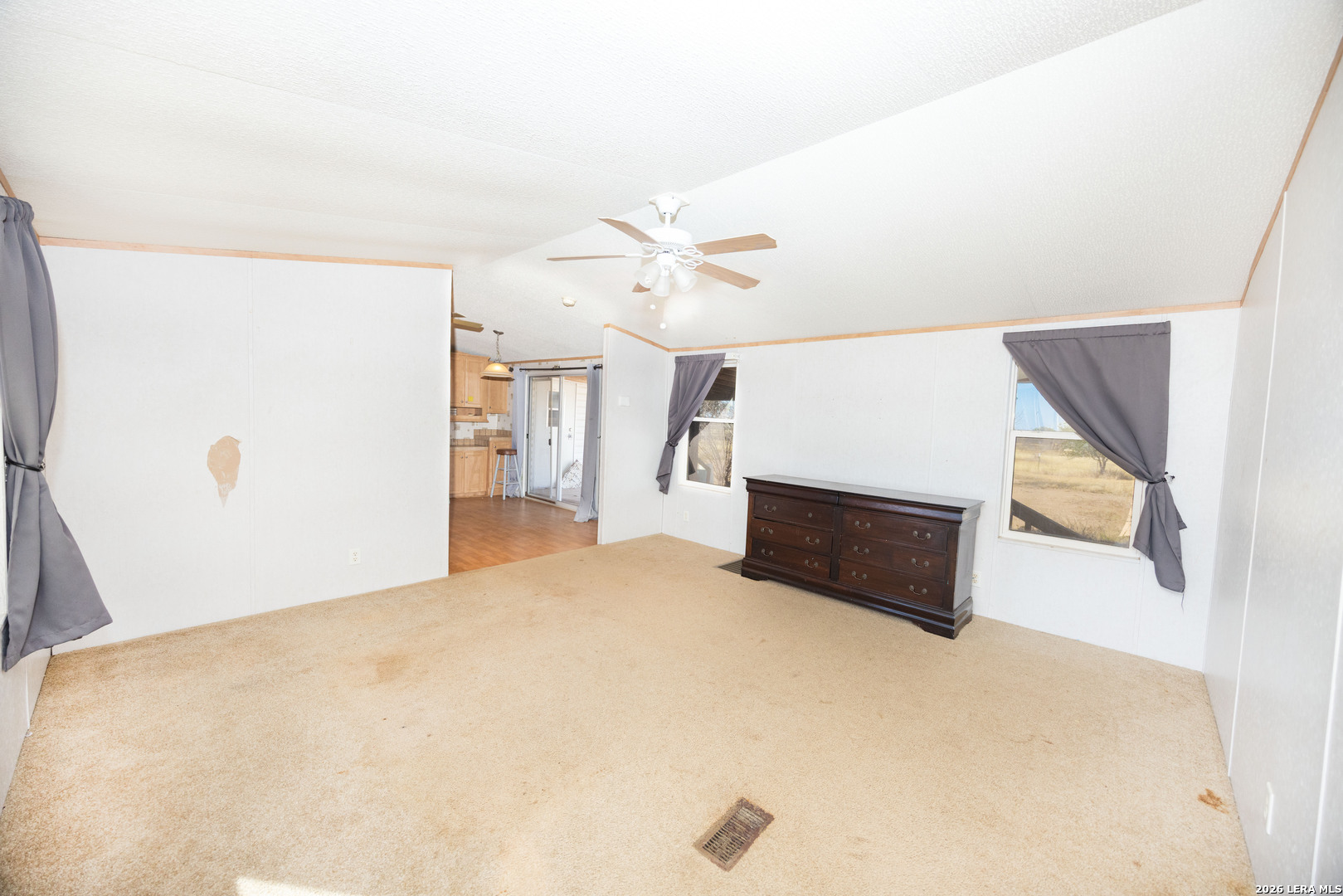 4919 County Road 545 Devine, TX 78016 - Photo 5 of 38 a bedroom with a bed and a ceiling fan