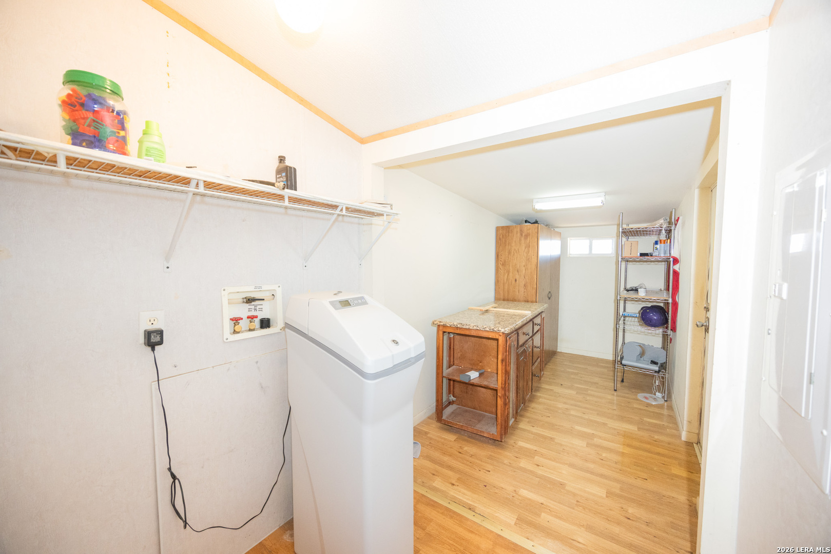 4919 County Road 545 Devine, TX 78016 - Photo 7 of 38 a view of a kitchen with furniture and wooden floor