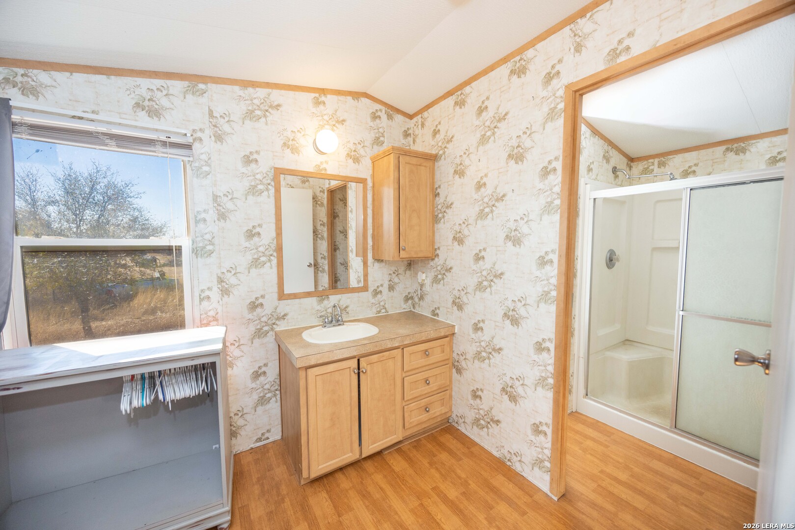 4919 County Road 545 Devine, TX 78016 - Photo 9 of 38 a bathroom with a double vanity sink toilet and shower
