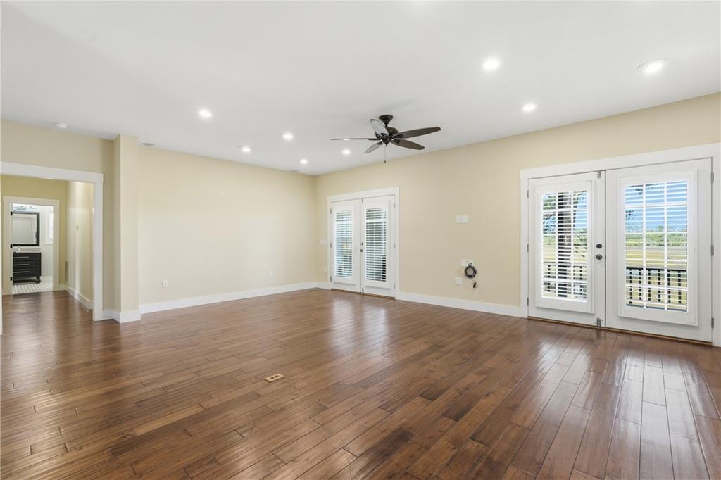 1261 Otter Slide Loop Townsend, GA 31331 - Photo 12 of 52 a view of an empty room with wooden floor and a window