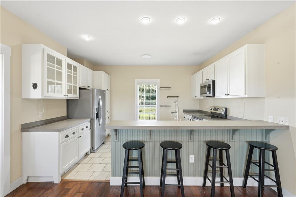 1261 Otter Slide Loop Townsend, GA 31331 - Photo 19 of 52 a kitchen with cabinets and chairs