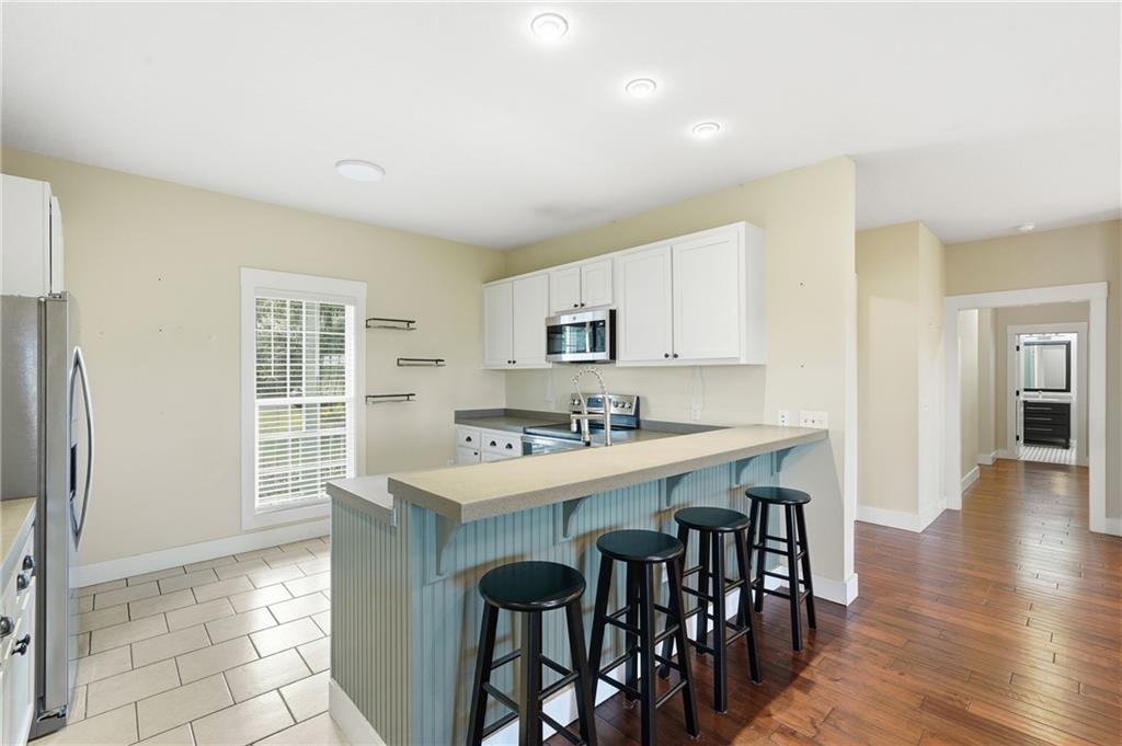 1261 Otter Slide Loop Townsend, GA 31331 - Photo 21 of 52 a kitchen with a table chairs sink and cabinets