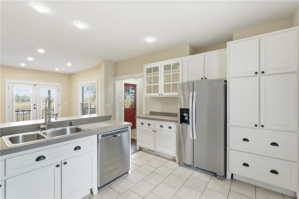 1261 Otter Slide Loop Townsend, GA 31331 - Photo 22 of 52 a kitchen with granite countertop cabinets and refrigerator