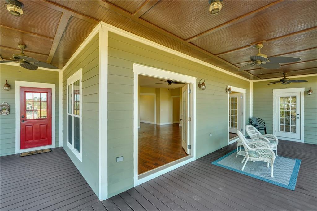 1261 Otter Slide Loop Townsend, GA 31331 - Photo 23 of 52 a view of outdoor space with wooden floor and windows