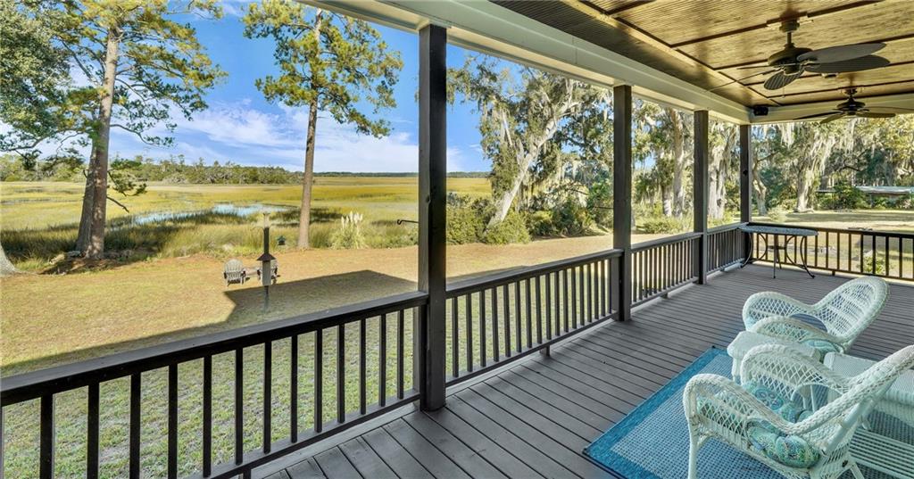 1261 Otter Slide Loop Townsend, GA 31331 - Photo 24 of 52 a view of a chairs and table in patio with wooden floor