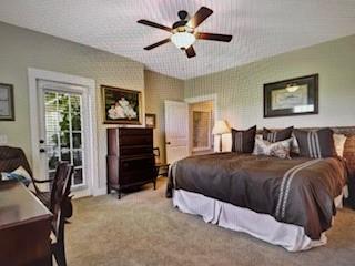 1261 Otter Slide Loop Townsend, GA 31331 - Photo 26 of 52 a spacious bedroom with a bed and a chandelier