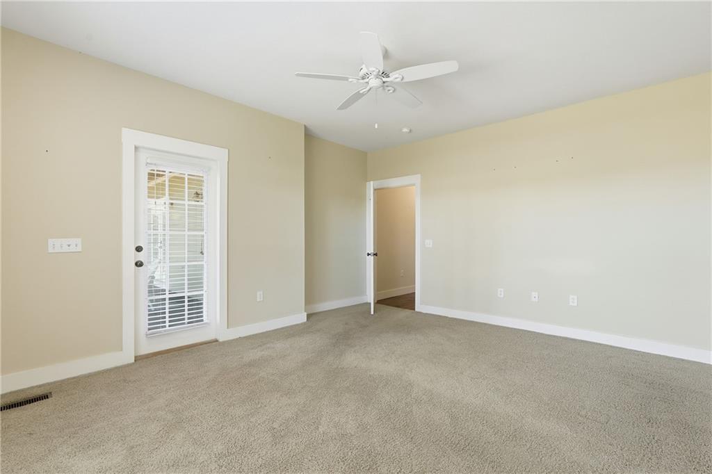 1261 Otter Slide Loop Townsend, GA 31331 - Photo 27 of 52 an empty room with a ceiling fan and a window
