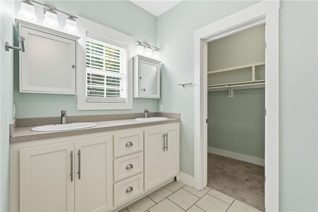 1261 Otter Slide Loop Townsend, GA 31331 - Photo 28 of 52 a bathroom with a granite countertop sink a mirror and a
