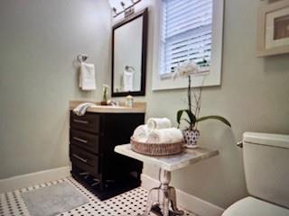 1261 Otter Slide Loop Townsend, GA 31331 - Photo 32 of 52 a bathroom with a sink a vanity and a mirror