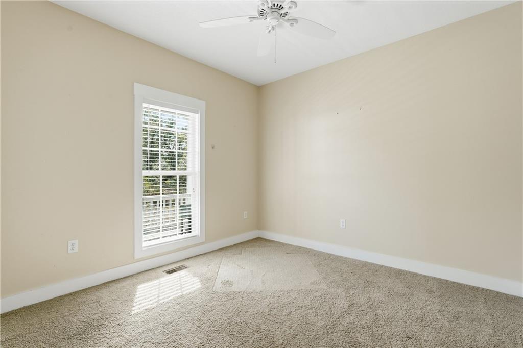 1261 Otter Slide Loop Townsend, GA 31331 - Photo 34 of 52 an empty room with windows and chandelier fan
