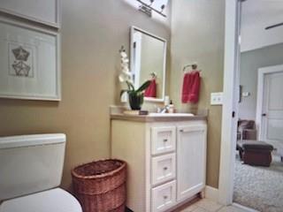 1261 Otter Slide Loop Townsend, GA 31331 - Photo 38 of 52 a bathroom with a toilet sink and mirror