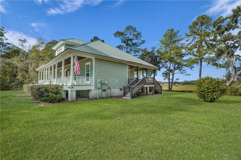 1261 Otter Slide Loop Townsend, GA 31331 - Photo 40 of 52 a front view of a house with garden
