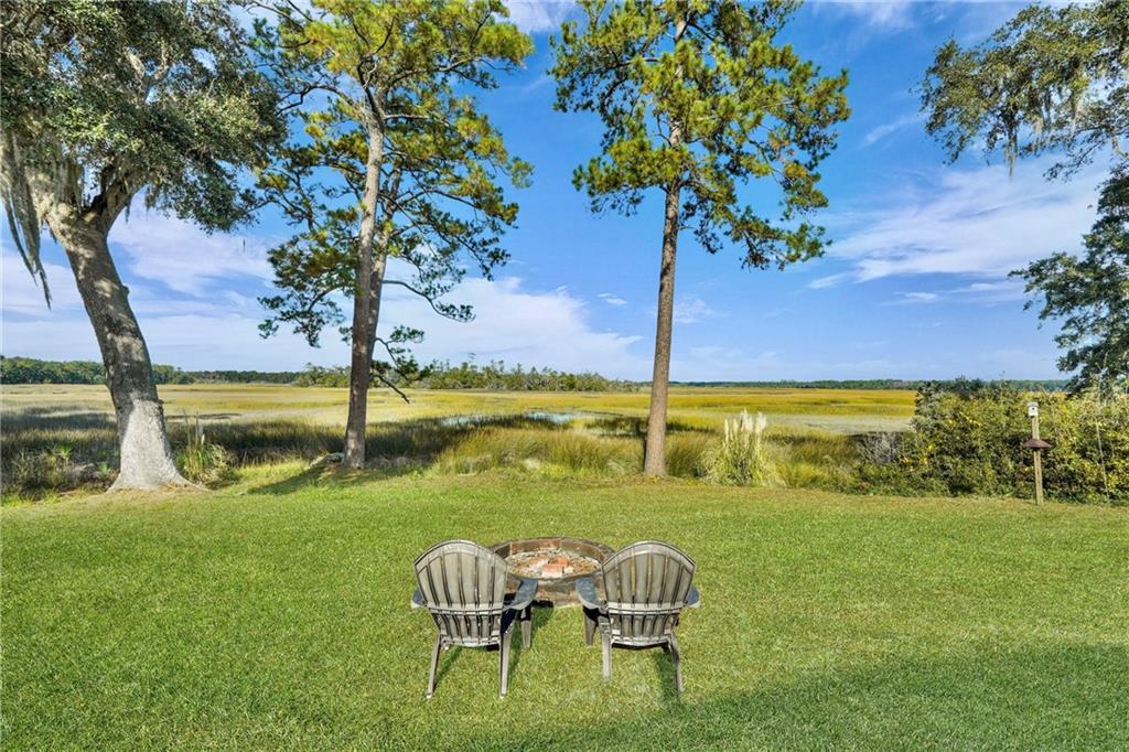 1261 Otter Slide Loop Townsend, GA 31331 - Photo 4 of 52 a view of a lake with a table and chairs