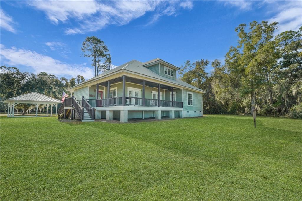 1261 Otter Slide Loop Townsend, GA 31331 - Photo 41 of 52 a front view of a house with a garden