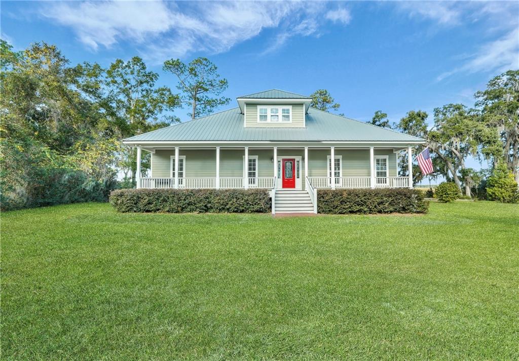 1261 Otter Slide Loop Townsend, GA 31331 - Photo 45 of 52 a front view of a house with a garden