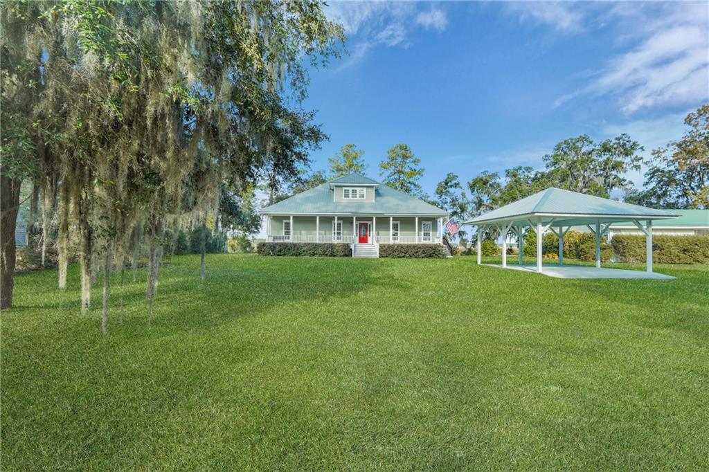 1261 Otter Slide Loop Townsend, GA 31331 - Photo 46 of 52 a view of an house with backyard and a tree