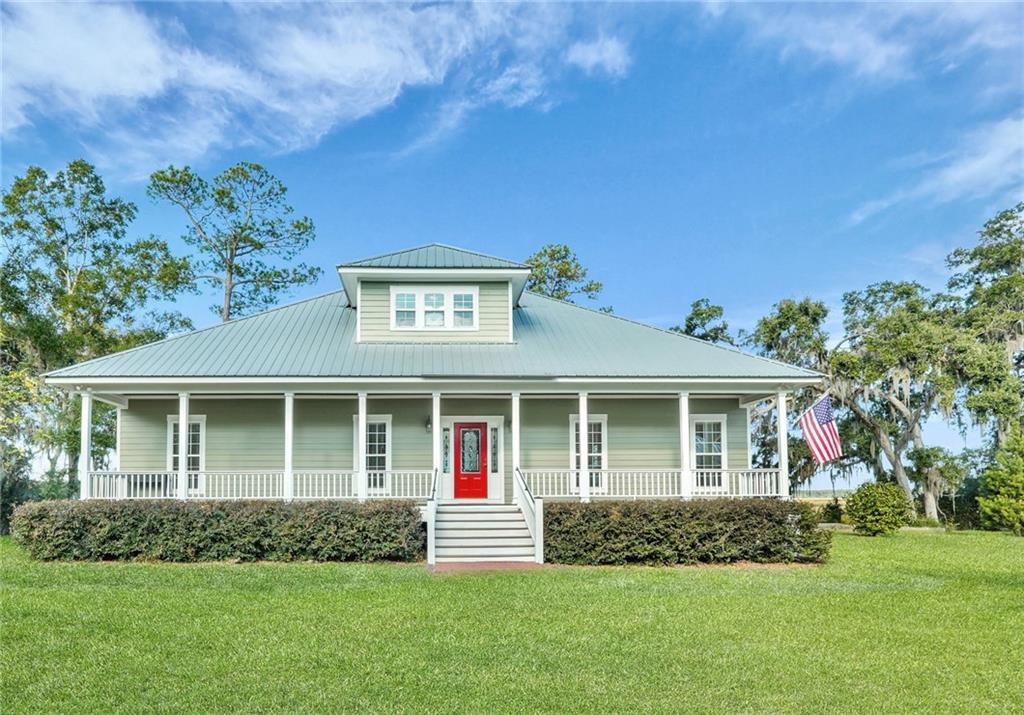 1261 Otter Slide Loop Townsend, GA 31331 - Photo 5 of 52 a front view of a house with a yard and garage