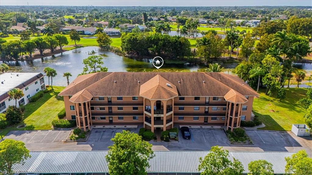 an aerial view of a house with a garden and lake view