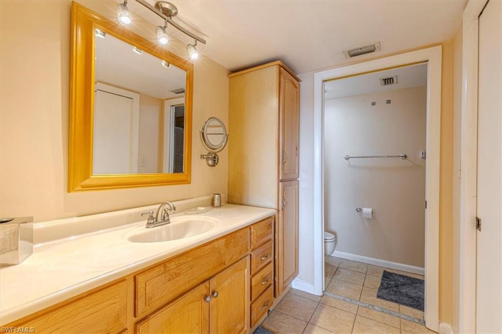 5535 Rattlesnake Hammock Road, Unit 302 Naples, FL 34113 - Photo 12 of 24 a bathroom with a sink and a mirror