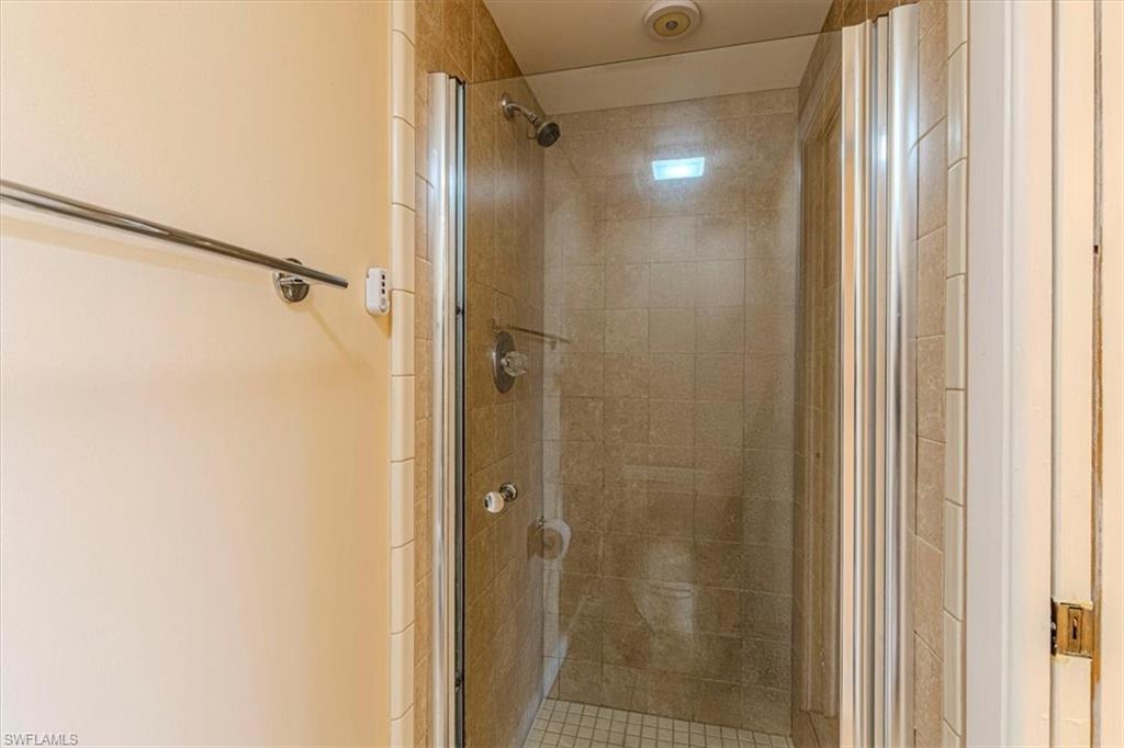5535 Rattlesnake Hammock Road, Unit 302 Naples, FL 34113 - Photo 13 of 24 a bathroom with a glass door shower