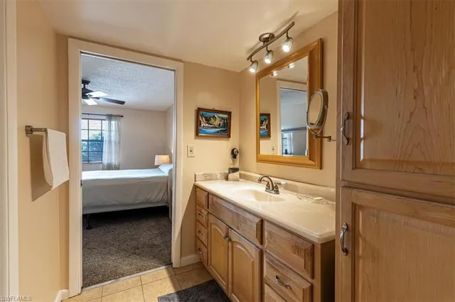 a bathroom with a double vanity sink a mirror and a bathtub