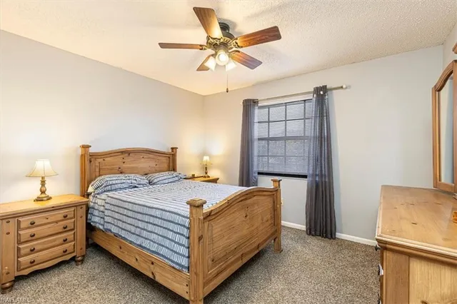a bedroom with a bed and a ceiling fan