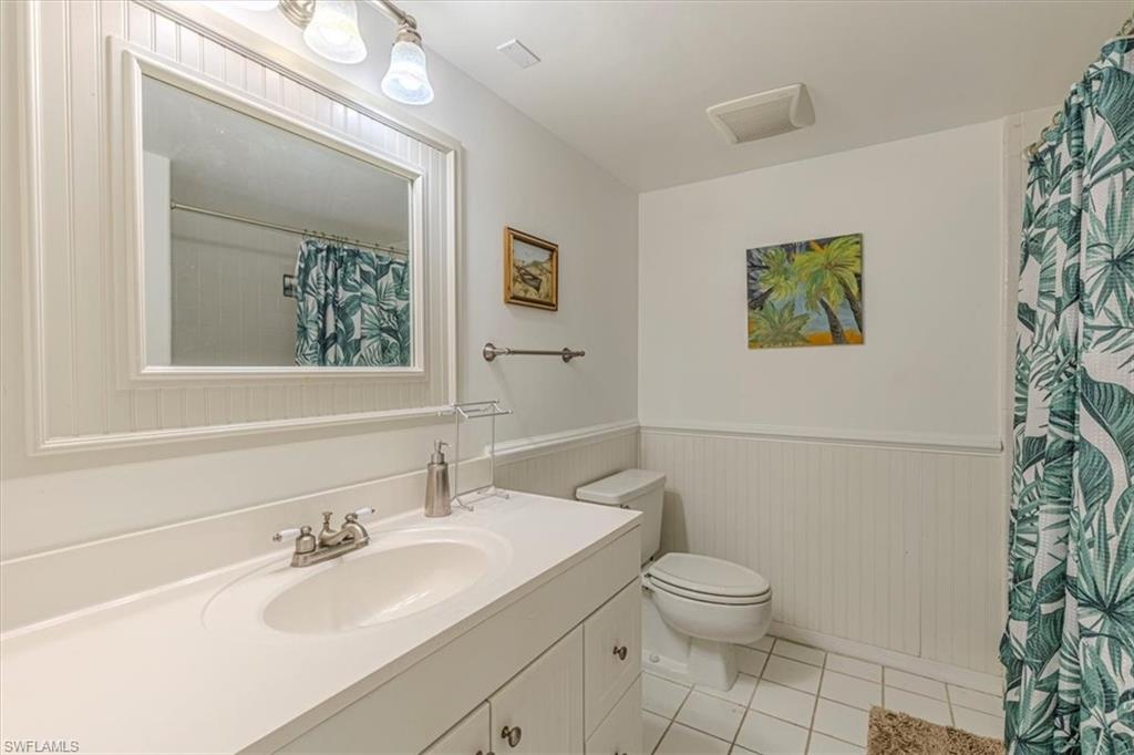 5535 Rattlesnake Hammock Road, Unit 302 Naples, FL 34113 - Photo 17 of 24 a bathroom with a toilet sink and mirror