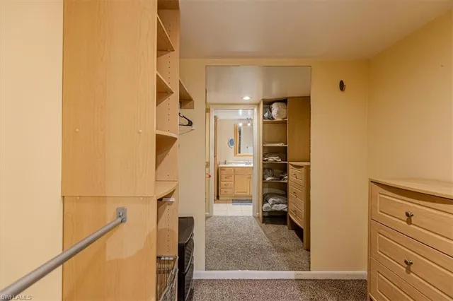 a view of walk in closet with clothes