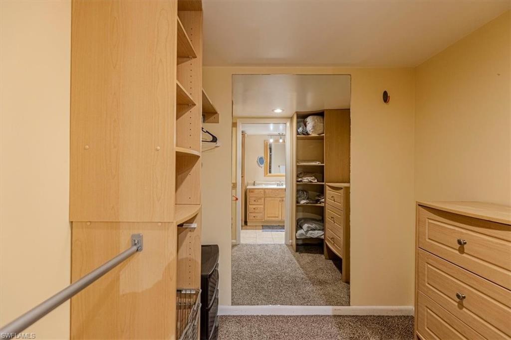 5535 Rattlesnake Hammock Road, Unit 302 Naples, FL 34113 - Photo 22 of 24 a view of walk in closet with clothes
