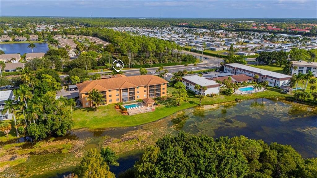 5535 Rattlesnake Hammock Road, Unit 302 Naples, FL 34113 - Photo 3 of 24 an aerial view of residential houses with outdoor space