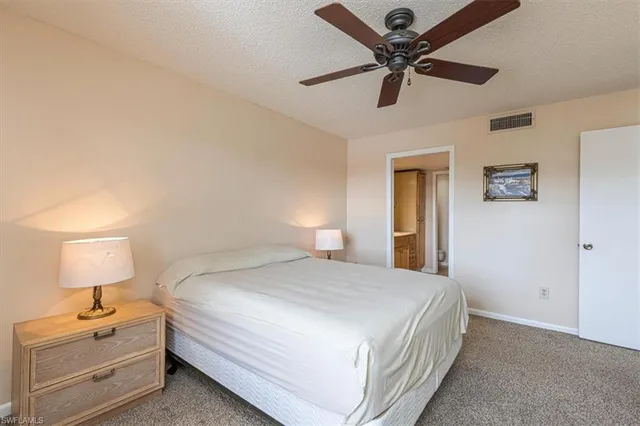 a bedroom with a bed and a lamp