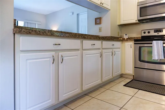 a kitchen with stainless steel appliances granite countertop a refrigerator and a stove