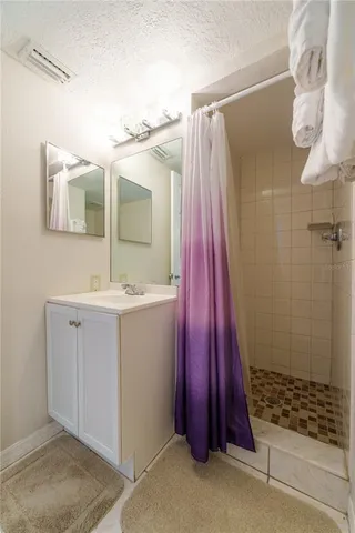a bathroom with a sink a mirror and shower