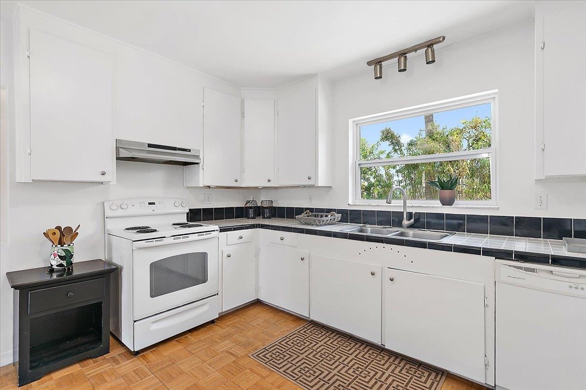 108 Ferrol Road St. Augustine, FL 32084 - Photo 13 of 39 a kitchen with granite countertop white cabinets and white appliances