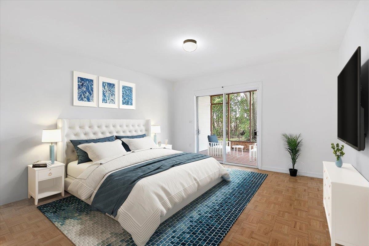 108 Ferrol Road St. Augustine, FL 32084 - Photo 17 of 39 a bedroom with a large bed and a flat screen tv